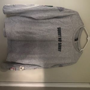 Grey “sorry not sorry” sweatshirt.